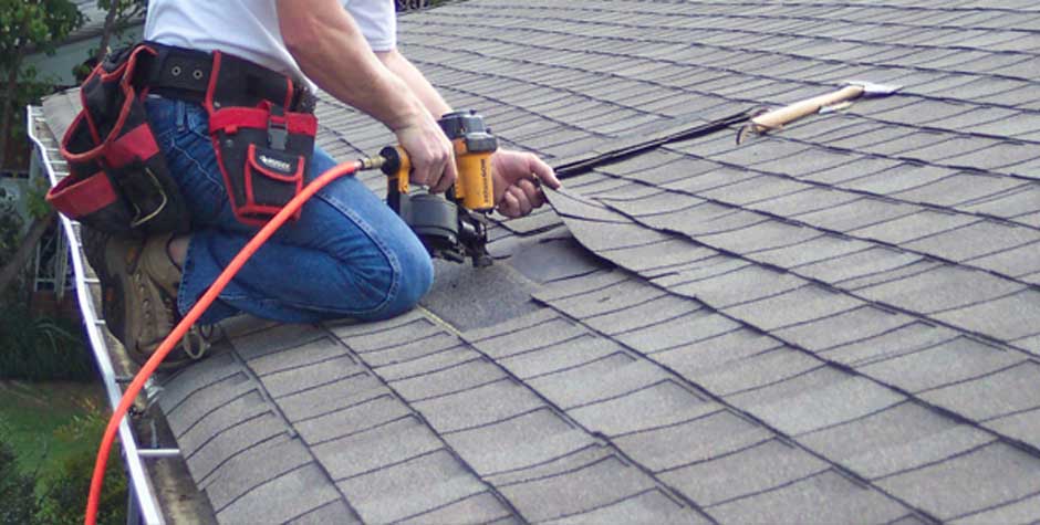 professional roofer repairing roof